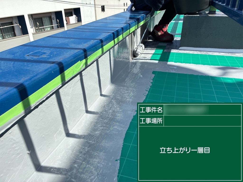 屋上の床面と壁面が接する立ち上がり部分に防水材を塗布する作業